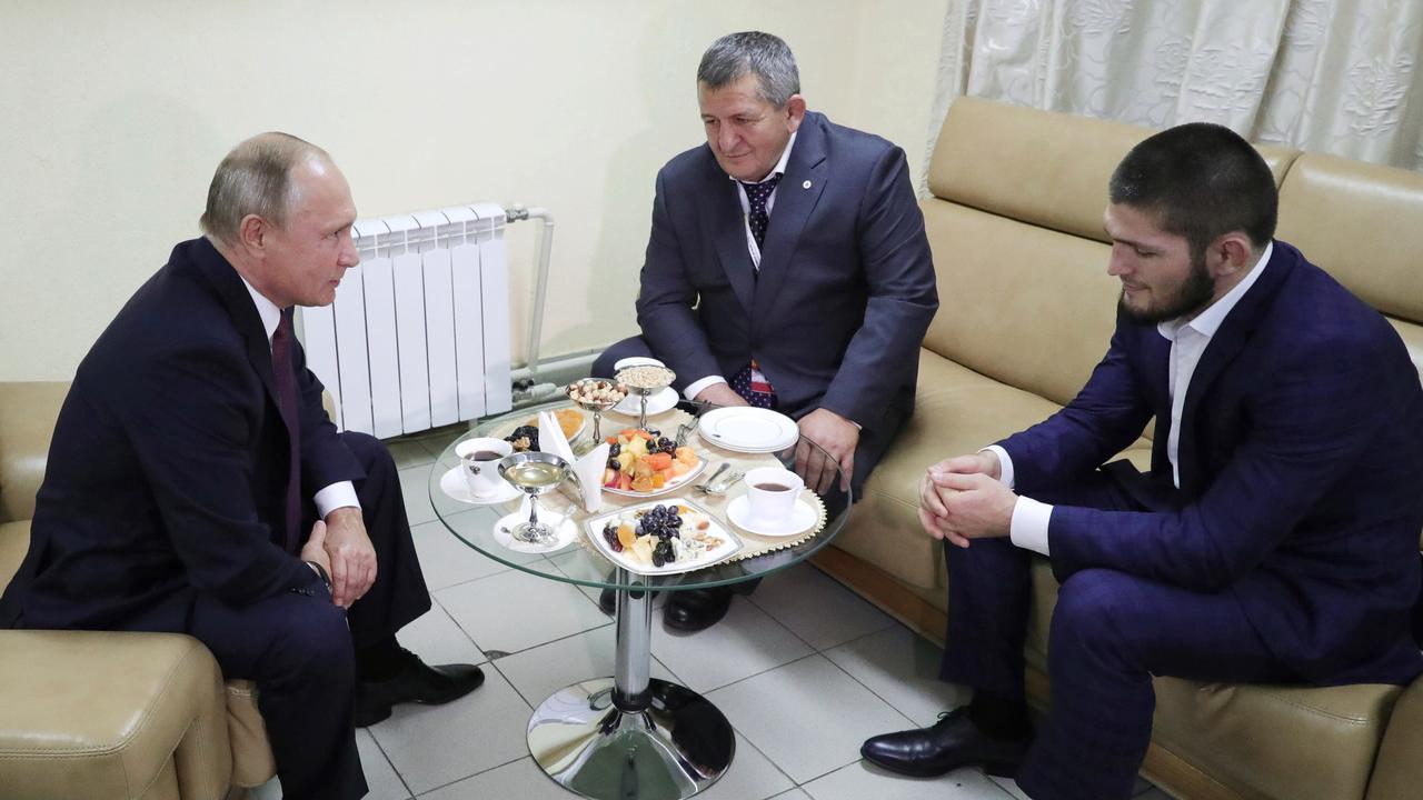 Russian President Vladimir Putin, left, meets with Khabib Nurmagomedov, right, who has won the UFC lightweight title, in Ulyanovsk on the Volga River, Russia, Wednesday, Oct. 10, 2018. Putin defended the fighter's actions in the brawl that followed his victory over Conor McGregor. Nurmagomedov's father Abdulmanap is in the centre. (Mikhail Klimentyev, Sputnik, Kremlin Pool Photo via AP)