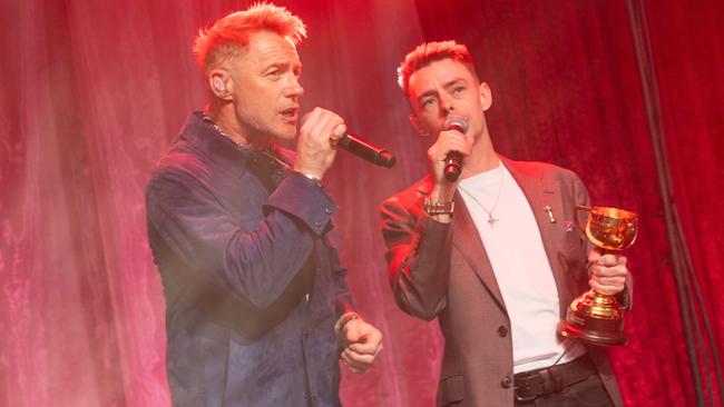 Robbie Dolan (right) sings with Ronan Keating at an Oaks Day lunch on Wednesday. Picture: Jake Nowakowski