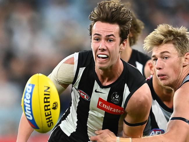 MELBOURNE, AUSTRALIA - MAY 23: Tyler Brown of the Magpies handballs whilst being tackled by Todd Marshall of the Power during the round 10 AFL match between the Collingwood Magpies and the Port Adelaide Power at Melbourne Cricket Ground on May 23, 2021 in Melbourne, Australia. (Photo by Quinn Rooney/Getty Images)