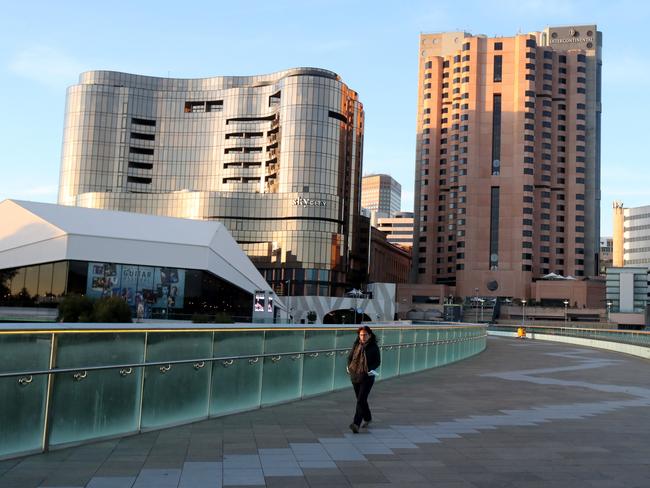 A woman walks along the Torrrens Footbridge on Wednesday. Photo by Kelly Barnes/Getty Images.