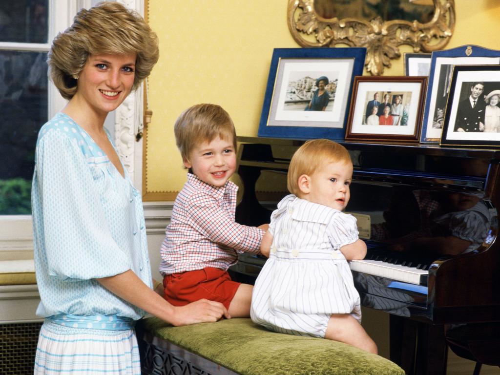 <b>1985:</b> The world gets its first real glimpse of Prince Harry in an adorable photo shoot with his mother and big brother Prince William in their apartment at Kensington Palace. The accompanying video footage, broadcast on TV at the time, gave insight into the dynamic between the siblings, with a bossy William firmly in charge of his toddler brother. Picture: Tim Graham Photo Library via Getty