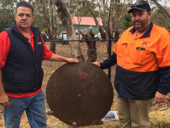 Record price: Paul Durden (left) with Brett Ford from Tungamah who bought the Furphy tank end for $17,000.