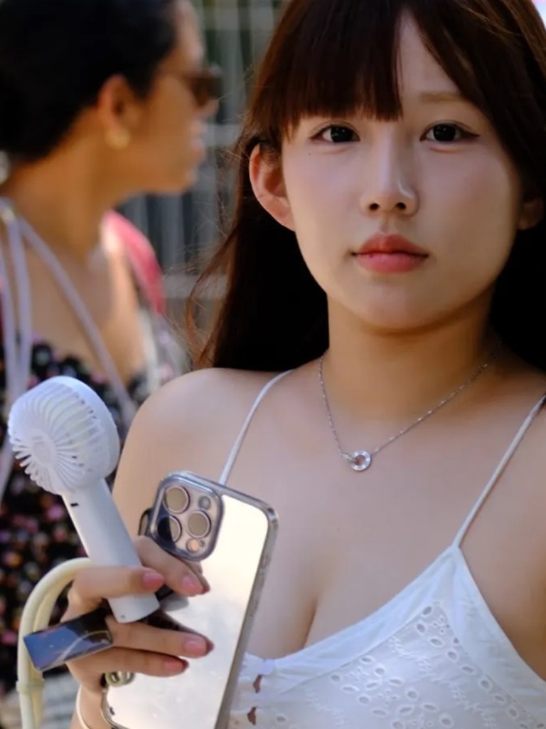 The handheld electric fan is everywhere. Picture: news.com.au