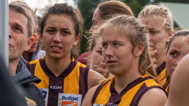 Rosie Dillon soaks up the instructions at a Hawthorn huddle Picture: Kadek Thatcher