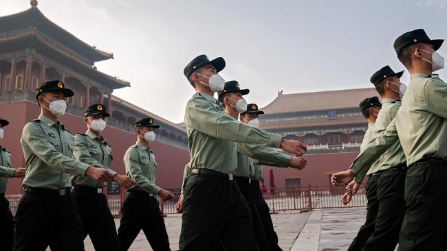 People's Liberation Army soldiers march next to the entrance to the Forbidden City in September. Picture: AFP