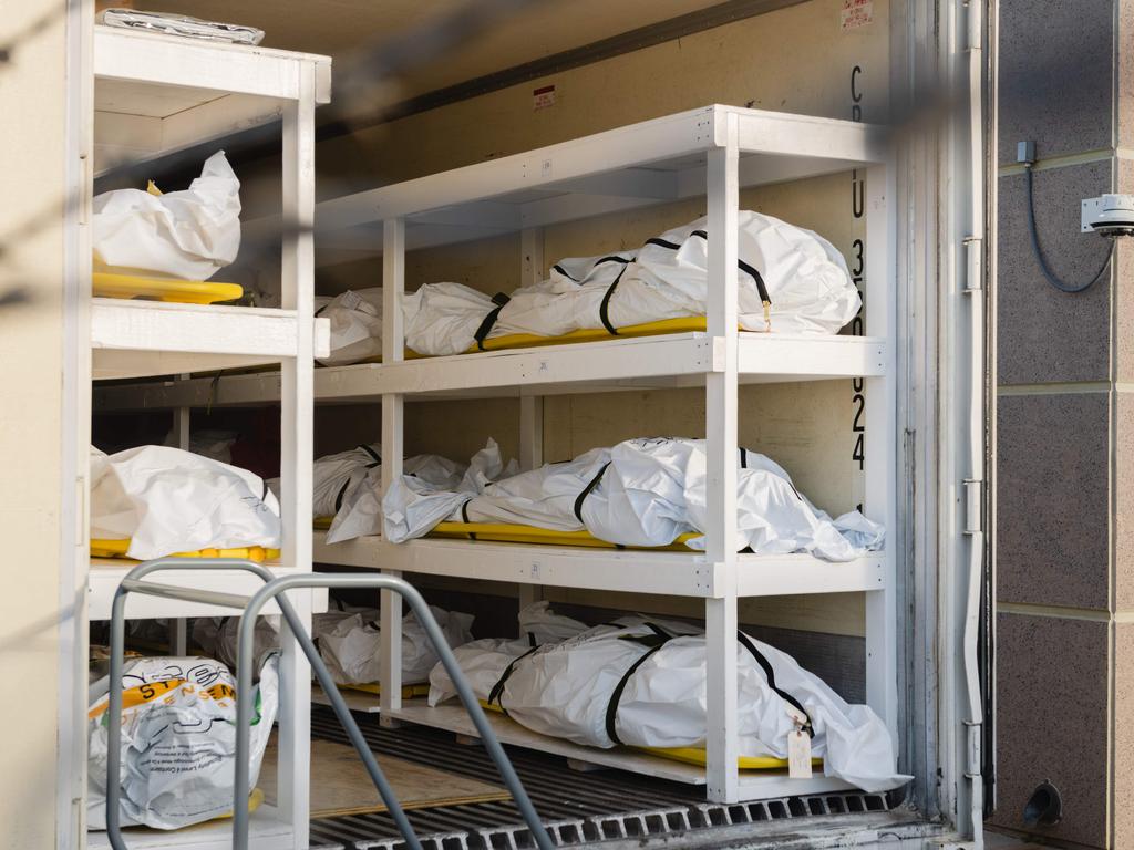 Bodies wrapped in plastic line the walls inside a refrigerated trailer used as a mobile morgue by the El Paso County Medical Examiner's office. Picture: Justin Hamel/AFP