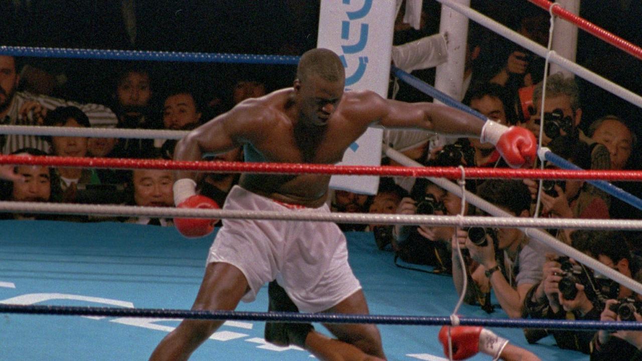 Challenger James "Buster" Douglas stands over Mike Tyson who fell on his back after taking a series of blows in the 10th round of their world heavyweight title fight in Tokyo. AP PHOTO