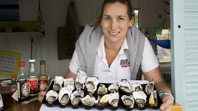 Cassie Melrose with some of the oysters produced at their farm, Melshell Oysters near Dolphin Sands. Picture: Kim Storey