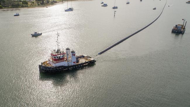 A tug pulled the pipe through the Broadwater today. Picture: Jerad Williams