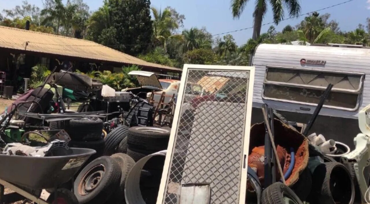 Cars and caravan parts at the Logan house.