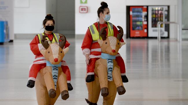 Staff dress up in Santa and reindeer costumes at an almost deserted Melbourne Airport amid changes to the NSW-Victoria border Picture: Andrew Henshaw