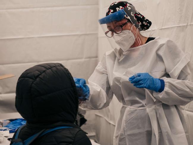 NEW YORK, NY - DECEMBER 27: A medical worker administers a COVID-19 test at a new testing site inside the Times Square subway station on December 27, 2021 in New York City. After a week of record-breaking positive COVID test rates, New York City officials and agencies are working to ramp up testing accessibility and turnaround times.   Scott Heins/Getty Images/AFP == FOR NEWSPAPERS, INTERNET, TELCOS & TELEVISION USE ONLY ==