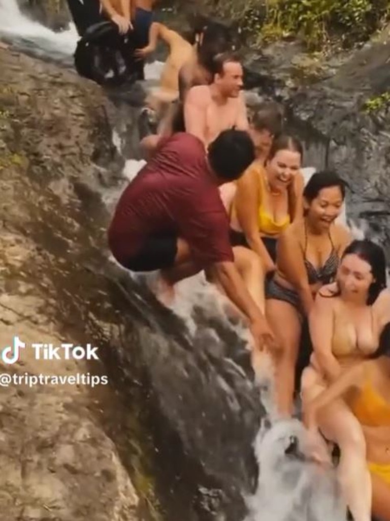 Tourists enjoying the ‘incredible’ Lemukih Waterfall slide. Picture: TikTok/triptraveltiips