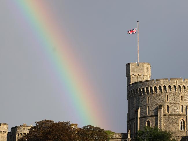 The Union flag is lowered on Windsor Castle after the Queen’s death, where a rainbow flashed across the sky. Picture: Chris Jackson/Getty Images