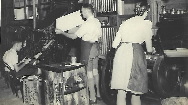 A family photo in the Macdonald Printing shop in the 40's. Stewart is operating the linotype, Jack Macdonald is looking at what is likely a proof, and a lady is hand-feeding a Chandler & Price press.