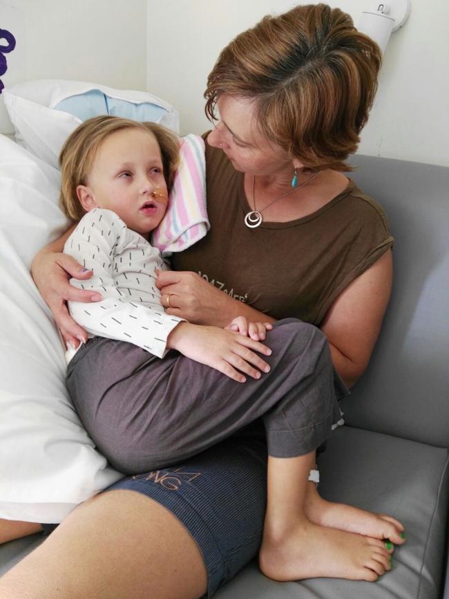 Ronan Osborne in hospital recovering from his stroke with his mother Amy. Picture: Supplied