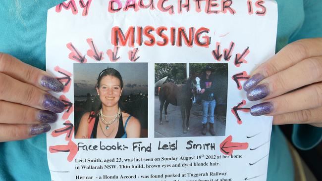 Leisl Smith’s mother Sandi Harvey holds up a sign for her missing daughter.
