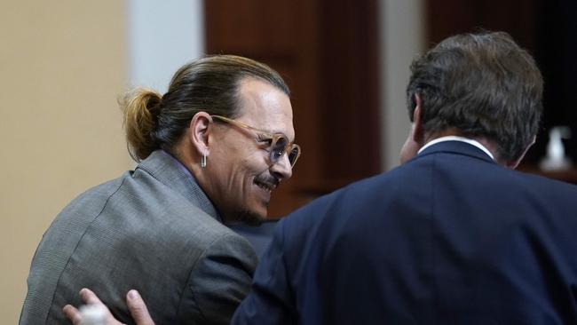 Attorney Ben Chew speaks to his client, actor Johnny Depp at Fairfax County Circuit Court during Depp's defamation case against ex-wife, actor Amber Heard as Heard takes the witness stand.