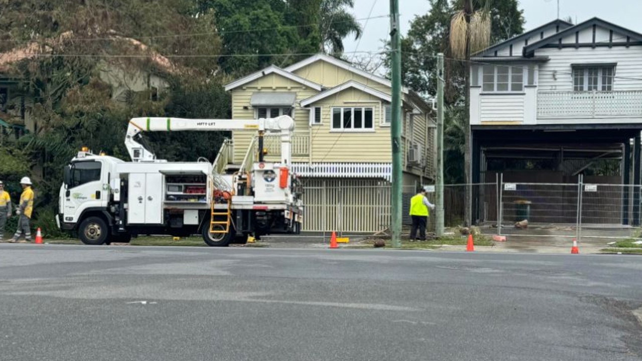 Energy workers on Vincent St at Auchenflower where four children were injured when a car hit a pole.