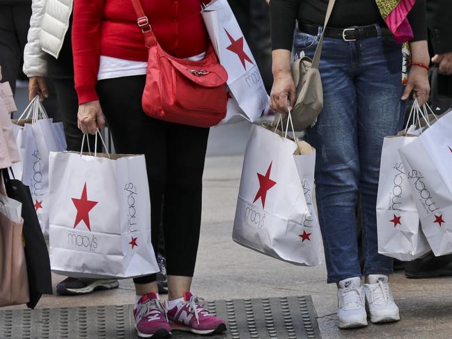 In this Tuesday, May 2, 2017, photo, shoppers holding bags from Macy's wait to cross an intersection in New York. Macy's Inc. reports earnings, Thursday, May 11, 2017. (AP Photo/Bebeto Matthews)