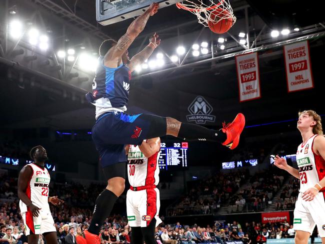 Rayjon Tucker throws down an authoritative dunk over Wildcat Corey Webster. Picture: Kelly Defina/Getty Images)