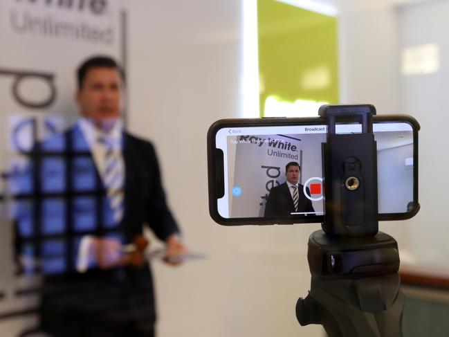 Auctioneer Peter Matthews holding an auction which is streamed online from Ray White Bondi where social distancing measures have been taken. This is one of the last Sydney home auctions being conducted before they are banned due to the Coronavirus pandemic. Picture: Jonathan Ng