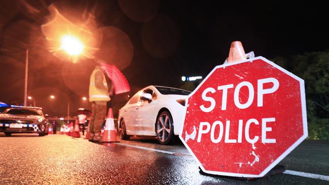 1am August 8 2020, Gold Coast Highway Coolanagatta Queensland - Queensland Police Officers with the assistance of The Australian Army stop all traffic into Queensland for checks at 1am on QLD/NSW border crossing due to increased lockdown of the State of QueenslandScott Powick Newscorp