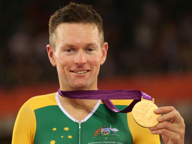 LONDON, ENGLAND - SEPTEMBER 01: Gold medalist Michael Gallagher of Australia pose on the podium during the medal ceremony in the Men's Individual C5 Pursuit Final on day 3 of the London 2012 Paralympic Games at Velodrome on September 1, 2012 in London, England. (Photo by Bryn Lennon/Getty Images)