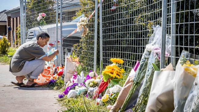 Floral tributes pile up at the house. Picture: Jake Nowakowski