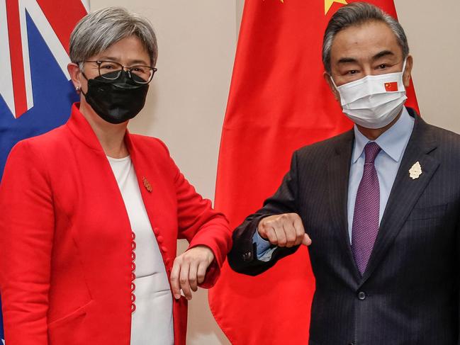 Australia's Foreign Minister Penny Wong (L) bumps elbows with China's Foreign Minister Wang Yi during their bilateral meeting on the sidelines of G20 Foreign Ministers Meeting in Nusa Dua on Indonesia's resort island of Bali on July 8, 2022. (Photo by Johannes P. CHRISTO / POOL / AFP)