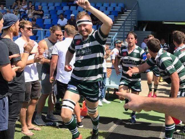 Lachlan Ward jumping in the air in his rugby uniform.