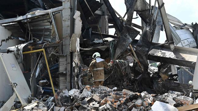 Rescuers clear rubble from the Amstor mall in Kremenchuk on Tuesday. Picture: AFP