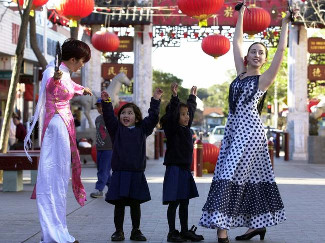 Anne Huang (L) and Spanish dancer Celia Garcia with five year olds Linda Chanthapanya and Susan Dorego Pereira who took part in the Moon Festival in Cabramatta in 2003.