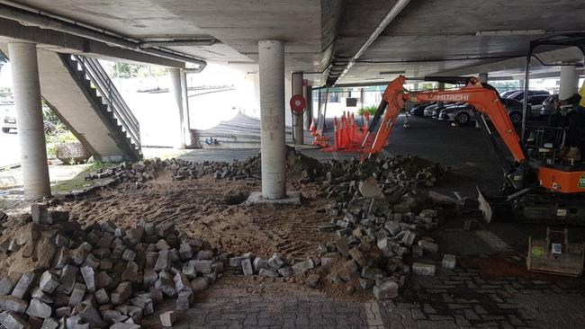 An excavator at the McGowan Dr carpark after a sink hole appeared.