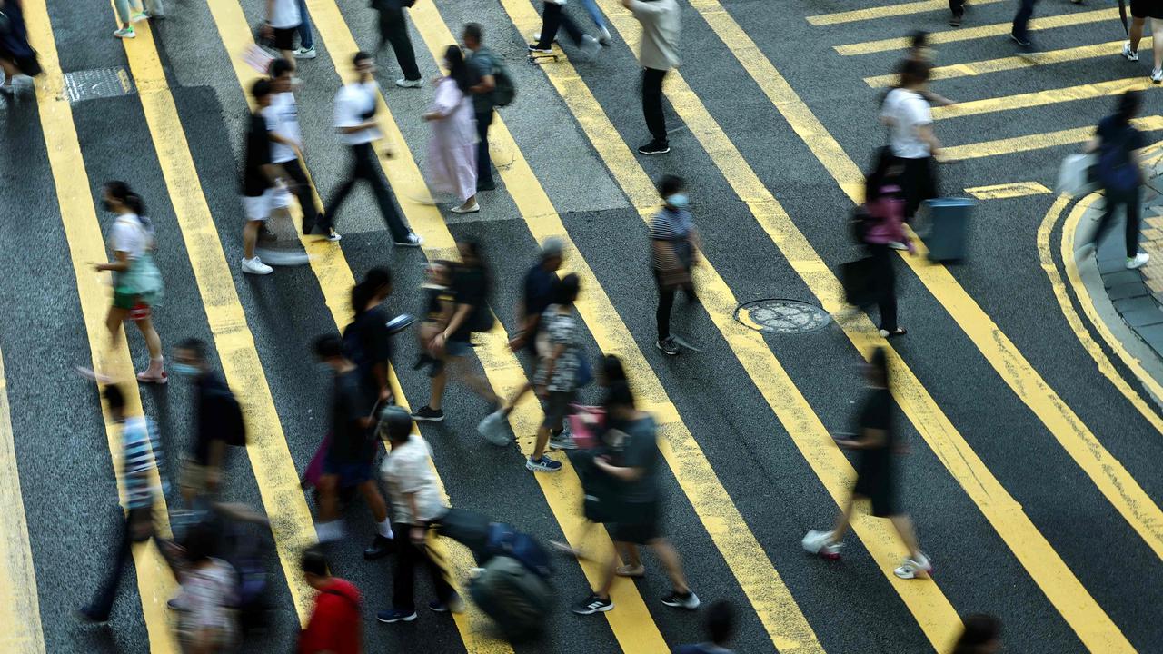 People cross a road in Central, a financial hub in Hong Kong on July 3, 2023. Picture: AFP