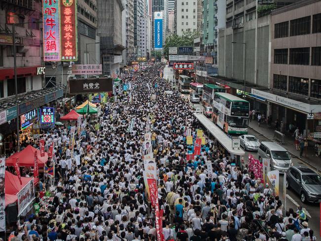 Demonstrators march during a pro-democracy rally in Hong Kong. AFP PHOTO/Philippe Lopez