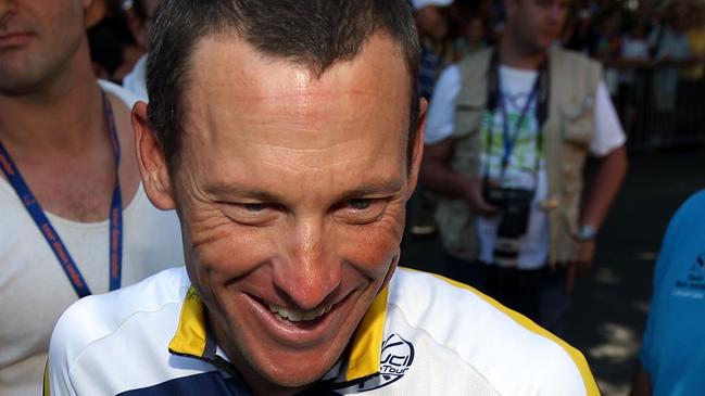 Cycling cheat Lance Armstrong is interviewed while holding a baby kangaroo before stage two of the 2009 Tour Down Under on January 21, 2009 in Adelaide, Australia. Photo by Ezra Shaw/Getty Images.