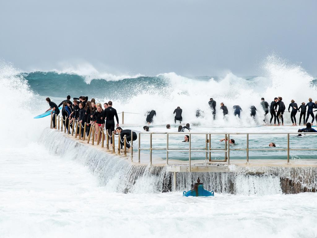 Teenagers chain-surf at South Curl Curl ocean pool as a large southerly swell hits the Sydney coastline on May 24, 2020 in Sydney, Australia. Winter weather including rain and strong winds is expected to continue through the weekend after Sydney and surrounds experienced a relatively mild May. (Photo by Cameron Spencer/Getty Images)