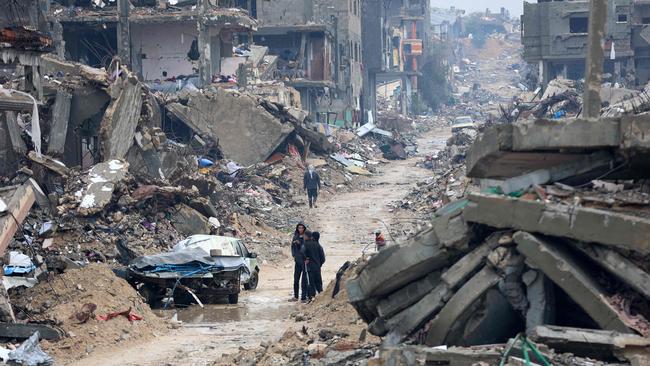 Palestinians walk amid the devastation in Beit Hanun in the northern Gaza Strip. Picture: AFP