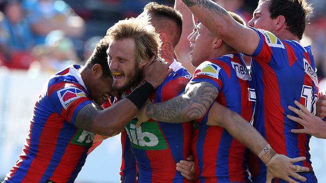 Nathan Ross of the Knights celebrates his try.