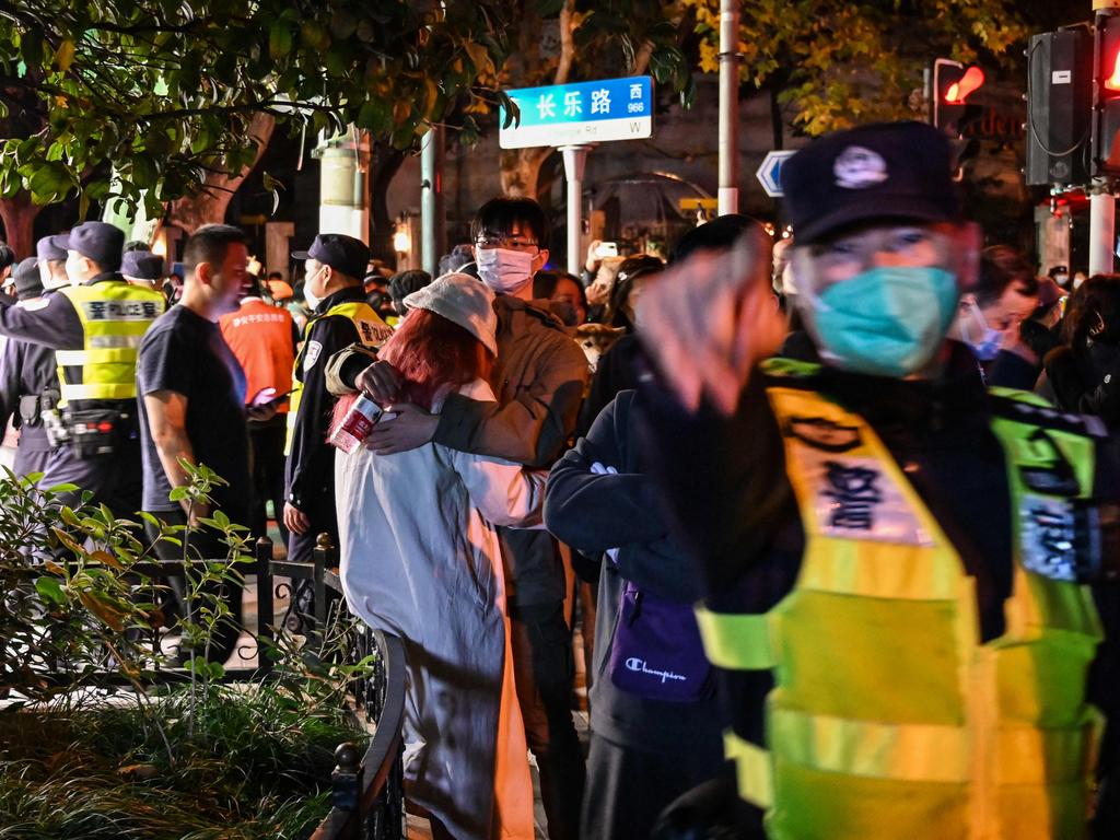 Police ask people to leave an area in Shanghai on Sunday. Picture: Hector Retamal/AFP