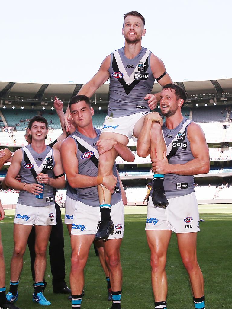 Rockliff and Travis Boak chair off Gray after his 200th game. Picture: Michael Dodge/Getty Images