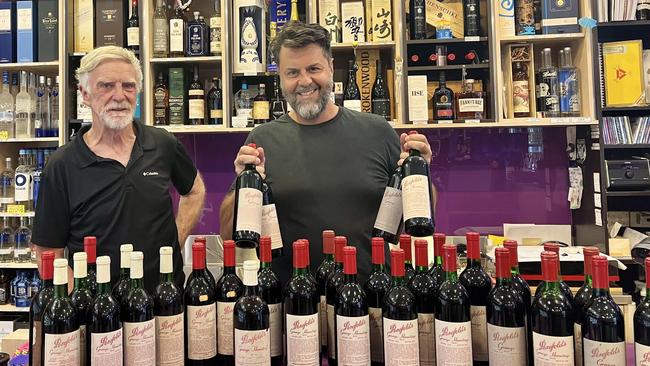 Randall Cadby (left) with his friend Kosta from Victoria Park Cellars and a few bottles from his collection.