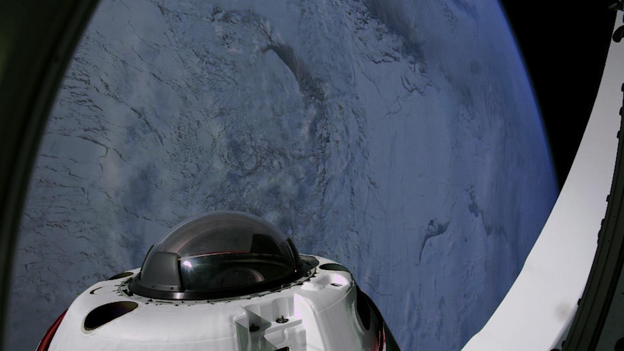 A polar region of the Earth can be seen through the domed window of the Dragon capsule. Picture: SpaceX via AP
