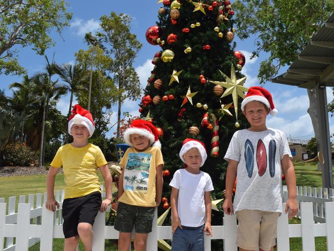 SANTA IS HERE: Billy, Oliver and Henry Dent and Cooper Monkman are excited to be spending Christmas in the picturesque Whitsundays. Here they are pictures in front of the Christmas Tree at the Airlie Beach Foreshore.