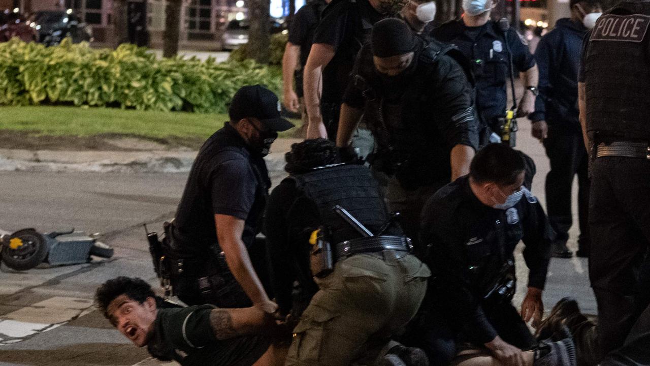 Riot police detain a man in Detroit. Picture: Seth Herald/AFP