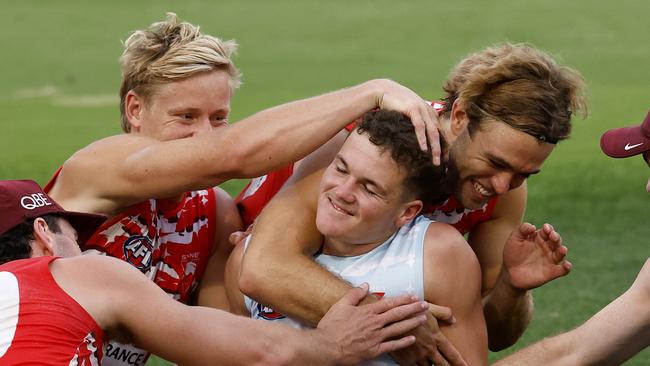 ** Embargo - 11.45 am today ** - Tom Hanily is congratulated after receiving the news from coach Dean Cox at training on Wednesday night that he will make his debut for the Swans against Hawthorn in the AFL Opening Round. Photo by Phil Hillyard (Image Supplied for Editorial Use only - **NO ON SALES** - Â©Phil Hillyard )