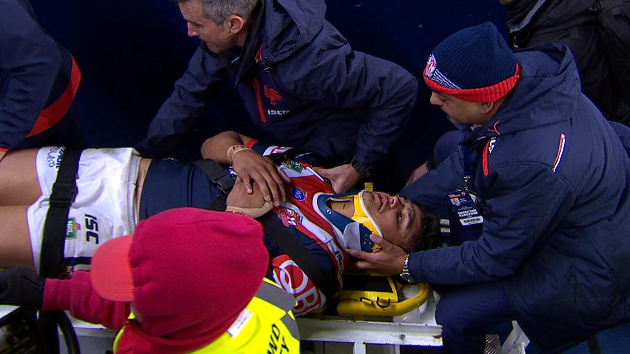 Roosters star Latrell Mitchell leaves the field on a medi-cab after a neck injury.
