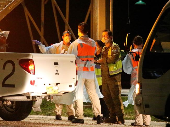 Crews including AUSMAT medical specialists greeted evacuees on the tarmac before they were driven out to the detention centre. Picture: Nathan Edwards