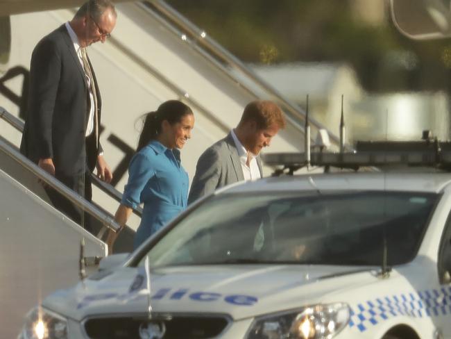 Harry and Meghan stepping out of the plane after a small delay. Picture: Matrix